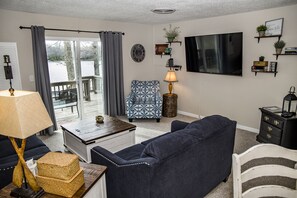 Comfortable living room includes 65 inch flat screen smart TV