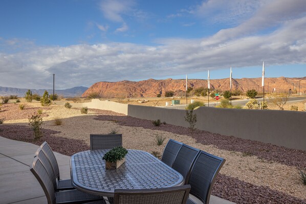 Back Patio Dining Table View - With plenty, of outdoor seating you are sure to enjoy grilling your favorite dish on the BBQ and dinner under the stars on this beautiful back patio area.