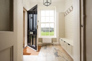 Seaview House - entrance porch / boot room with bench seat and hanging space for outdoor kit