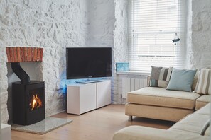 The lounge with a log burner at Chance Cottage, Cornwall