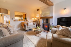 Pond Cottage, Docking: Sitting room with wood burning stove
