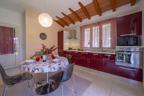 The kitchen is modern and has an exit into the garden