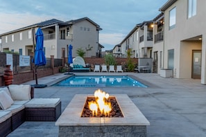 Backyard with fire pit and pool.