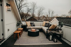 The rooftop features a large outdoor sectional with plenty of seating and a gas firepit for chilly Nashville nights.