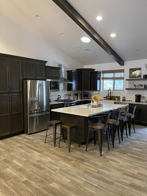 Kitchen with oversized island and seating for six.