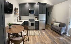 Kitchen with dishwasher, microwave, stove and oven, and refrigerator.  