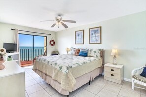 The primary bedroom has an ocean view, king bed, TV and a walk-in bathroom.