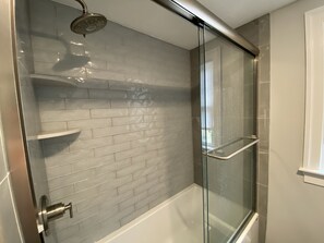 Full bathroom 1 upstairs. Glass tiles in shower.  