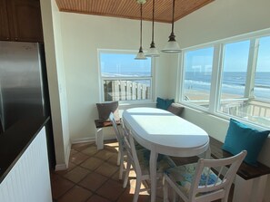 Dining room table with bench seating overlooking the ocean