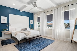 The master bedroom is the epitome of serenity in style with its stunning architecture and dreamy blue color palette accentuated by water and sky views