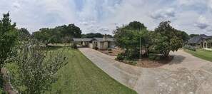 Front of the  house showing circular drive  and drive to carport and garage