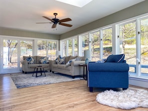 Windows all around Sunroom and Living Area off of Open Kitchen and Dining.
