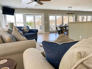 Windows all around Sunroom and Living Area off of Open Kitchen and Dining.