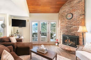 Living room with smart tv, gas fireplace, pull out sofa
