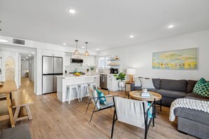 Living/dining/kitchen all open to the patio with ocean view
