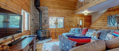 Living room with wood stove, flatscreen TV, and comfortable furniture