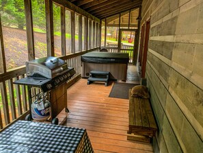 Screened in hot tub and grilling area