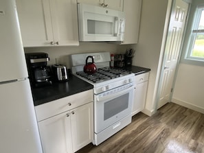 Kitchen with microwave range hood