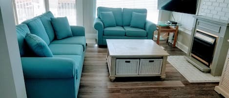 Comfortable seating area with views of the beach and dunes.