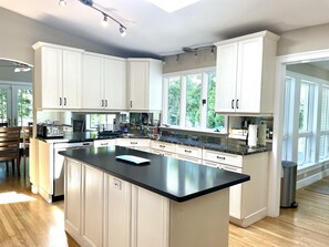 Well-appointed cook's kitchen with granite countertops.