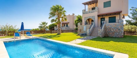 Beautiful villa with private pool, lawn, and terrace with sea views