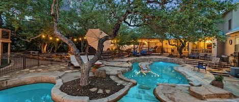 View of two pools at twilight. Pool #1 is 3' -5'-3'  Pool #2 is 9' deep w/slide