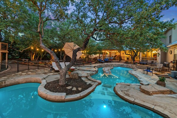 View of two pools at twilight. Pool #1 is 3' -5'-3'  Pool #2 is 9' deep w/slide