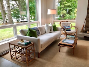 Main living space with views of North Lake Leelanau and forested yardscape