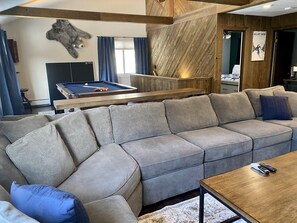 The large comfy sectional has room for everyone! Gather around to watch a movie.