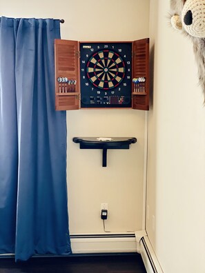 Electronic dart board with directions provided. Extra tips in kitchen drawer. 