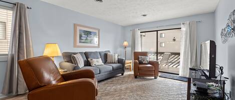 Walk right out on to the balcony from this comfy living room.