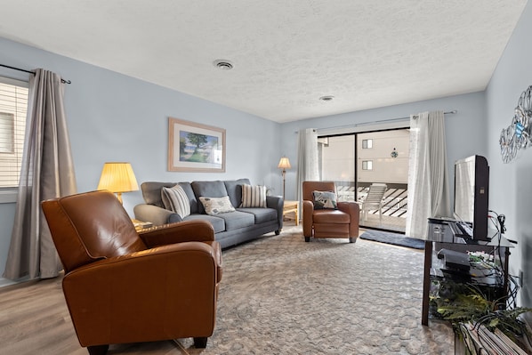 Walk right out on to the balcony from this comfy living room.