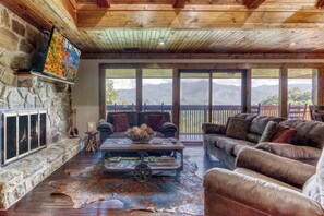 Rustic elegance with a panoramic mountain backdrop from the sofa.