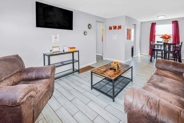 The living room boasts a sleek and modern design, featuring stylish furnishings, clean lines, and a sophisticated ambiance for a refined yet comfortable space.