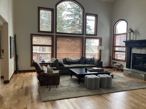 Living room with gas fireplace and 85" TV