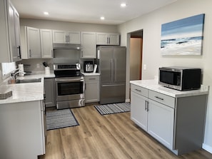 Updated kitchen with new cabinets and stainless appliances.