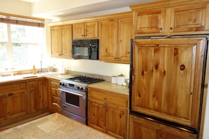 Kitchen with all utensils, spices, pans, etc.