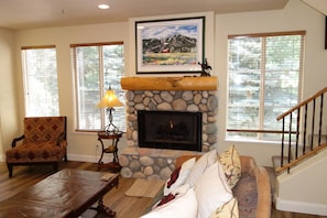 Fireplace and stairs leading to bedrooms