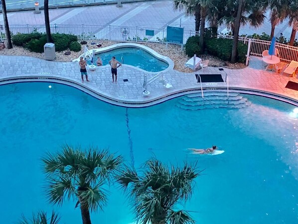 Hot tubs are spotted around the various pools
