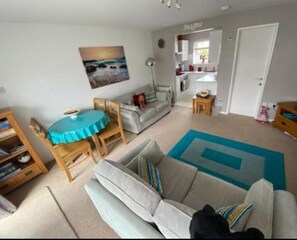 living area.  2 sofa's, dining table and chairs and TV.