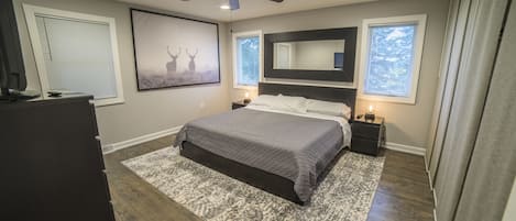 Large main bedroom with king size bed and modern furnishings.