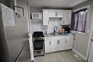 The kitchen is fully equipped with modern appliances, ample counter space, and all the essentials needed for a seamless cooking experience.
