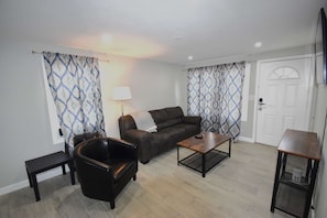 The living room is spacious and inviting, offering plenty of room to relax and unwind in comfort.