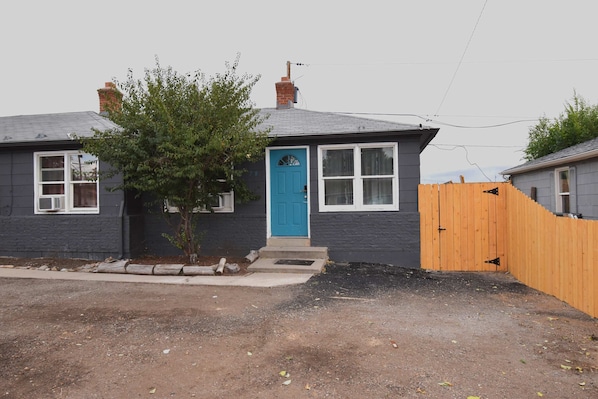The home features a charming blue door, adding a welcoming and stylish touch to the entrance.