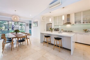 Channel your inner chef in the modern kitchen with an electric oven, a spacious walk-in pantry and Corian benchtops for meal prep. Start your day with freshly brewed coffee from the Nespresso machine.