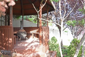 gazebo with seating and wood burning stove 
