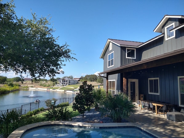 Back yard view of pool, covered patio and cove