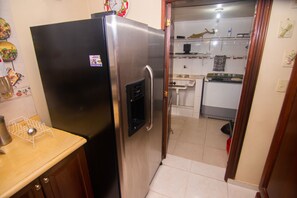 Fridge and laundry room with washer and dryer. 