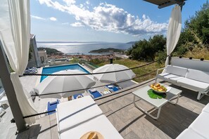Breathtaking sunset views in a stylish 5-bedroom villa, with a private 32 sqm pool, 4 bathrooms, 2 living rooms, and 2 kitchens