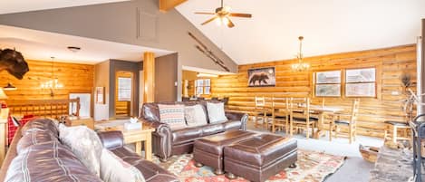 Spacious living area with enough seating for the whole family or friend group. Featuring a wood burning fireplace, flat screen TV, and sweeping slope views.